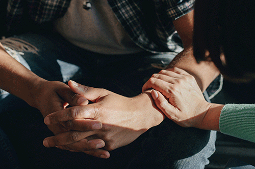 Woman comforts person in trauma therapy program